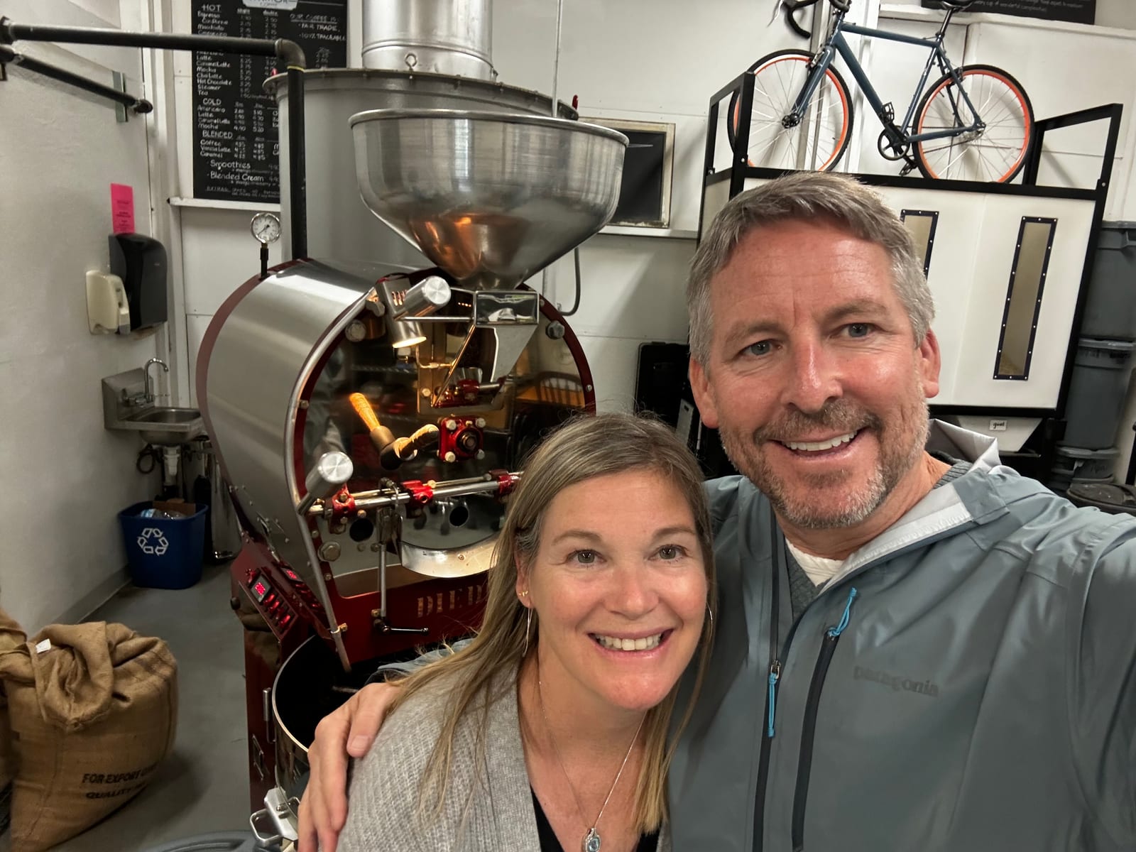 Bill and Kara Beckman together beside Aviator's coffee roaster