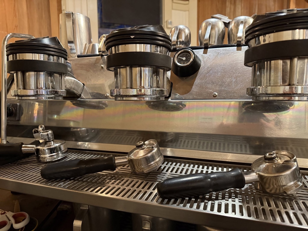 Polished espresso group heads and portafilters at the Aviator coffee bar